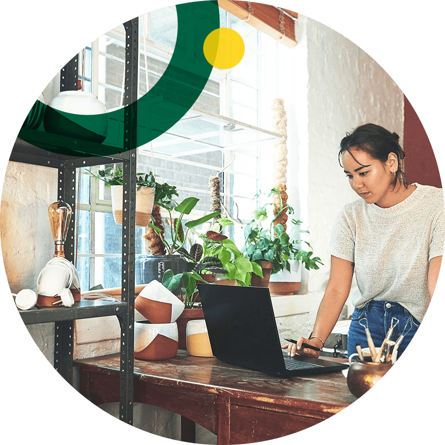 Pottery business owner using computer