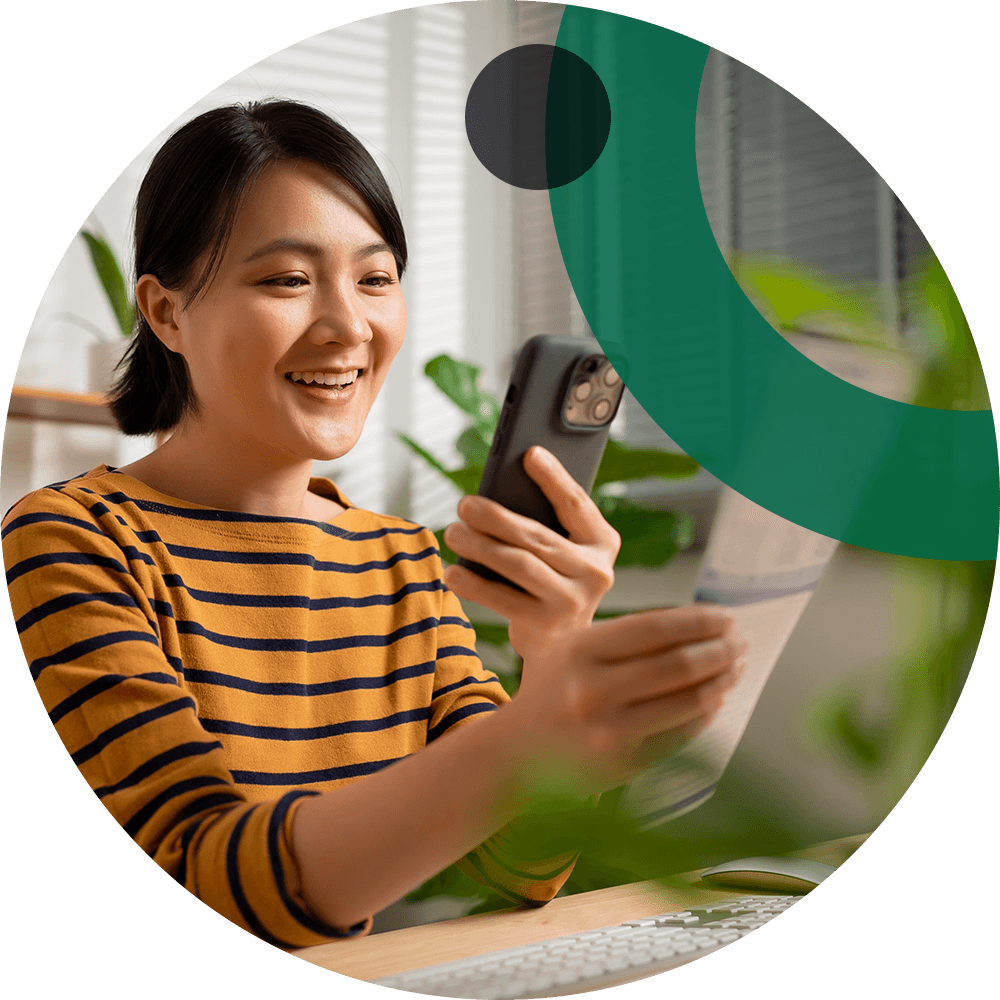 Young woman depositing a check via scanning from her mobile phone