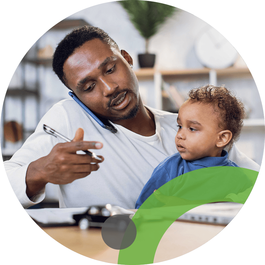 Working father on the phone holding a baby