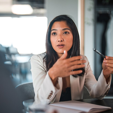 Woman presenting an idea in a corporate meeting.