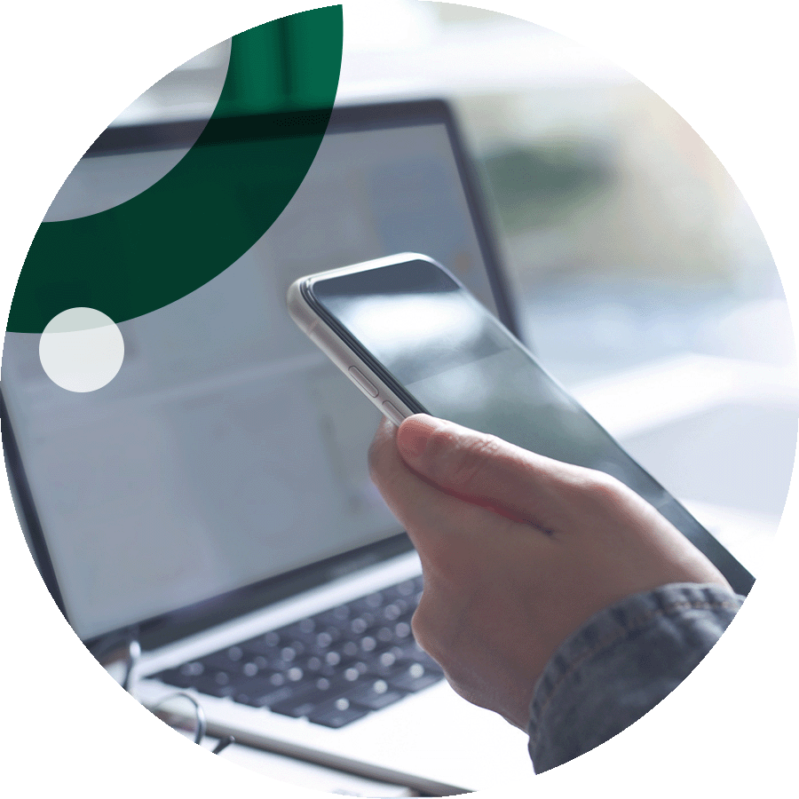 Business person using laptop and cell phone