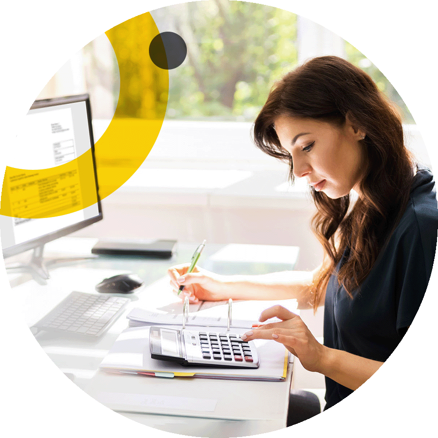 Business woman making calculations at her computer