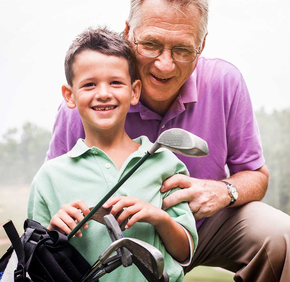 Teaching grandson to play golf.